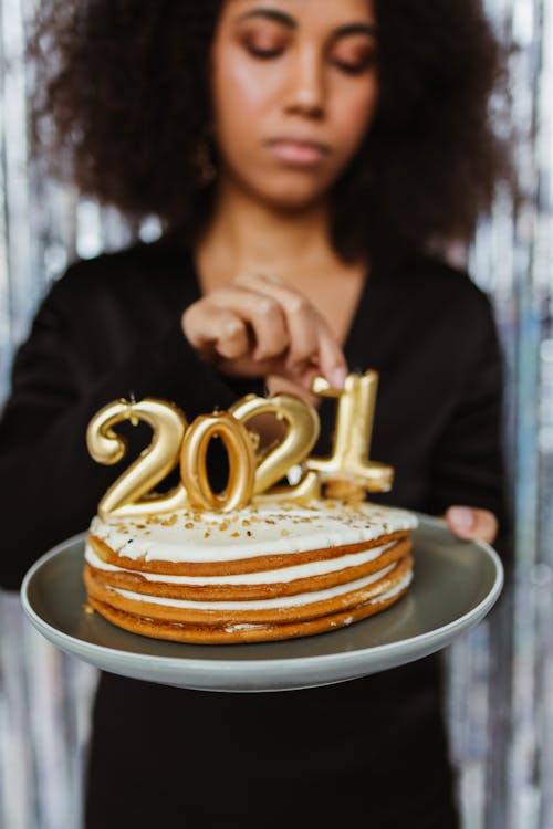 A Woman Celebrating the New Year with a Cake