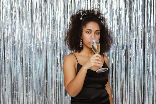 Woman in Black Dress Drinking a Champagne