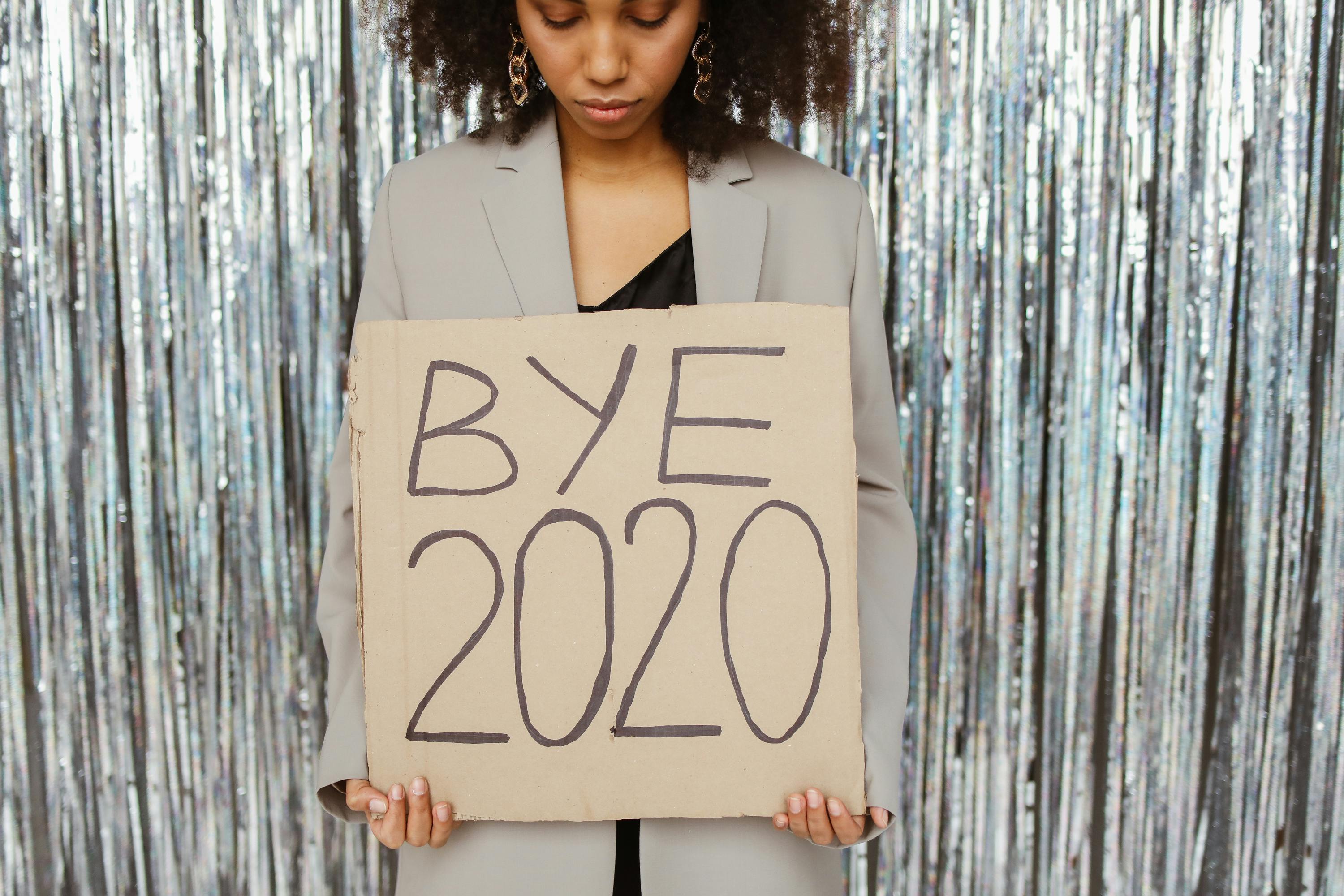 a tired woman holding a sign about burnout