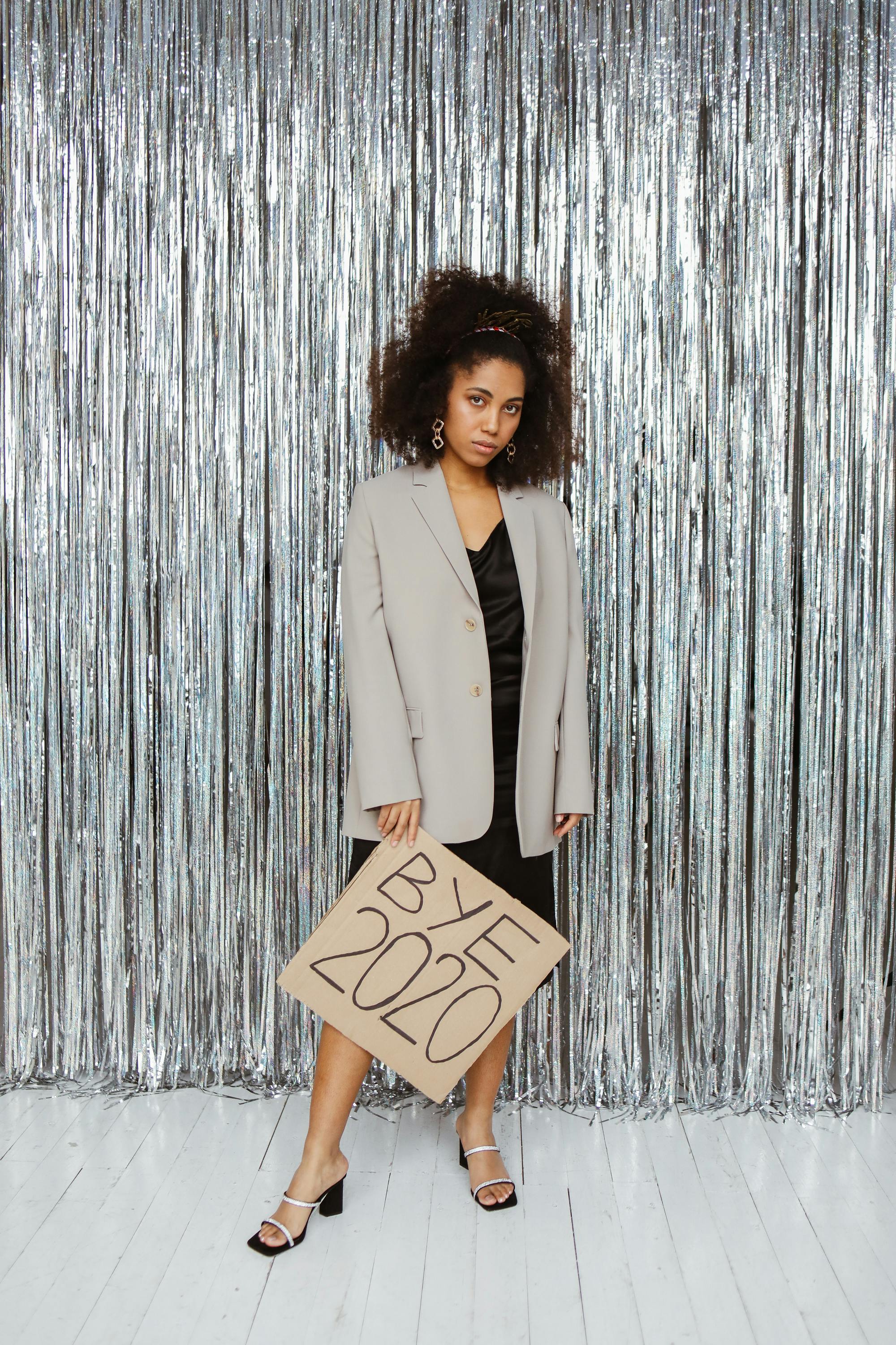 woman in gray blazer holding a cardboard