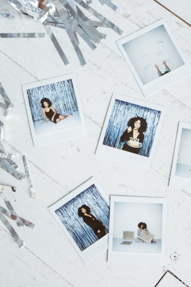 Polaroid Pictures On White Wooden Surface