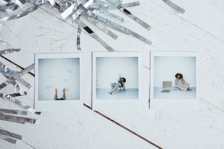 Polaroid Pictures On White Wooden Surface