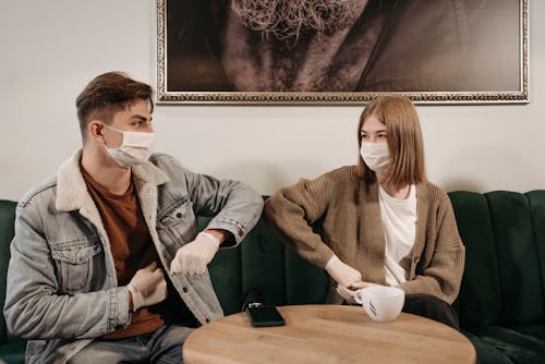 Free Woman and Man Sitting on the Sofa Stock Photo