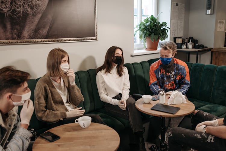 Group Of People Sitting On The Sofa