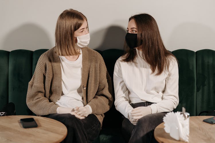 Women Wearing Facemasks Looking At Each Other