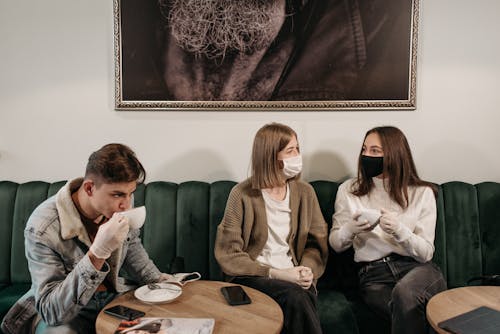 Free People Sitting on a Sofa in a Coffee Shop Stock Photo