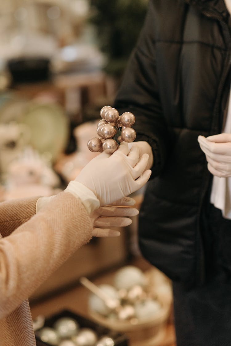 Person Holding Round Ornaments