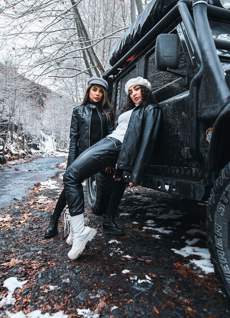 Women In Black Leather Jackets Leaning On A Car