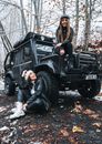 Women Sitting on a Black Vehicle