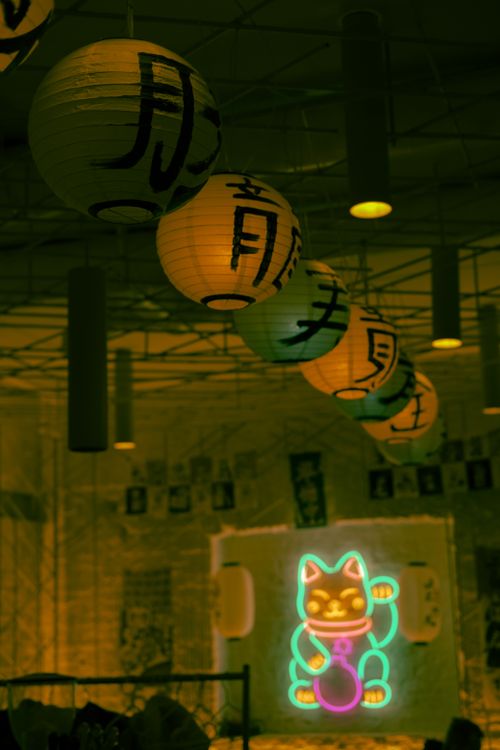 Free Colorful lanterns and neon cat light create an atmospheric indoor scene with Japanese influences. Stock Photo