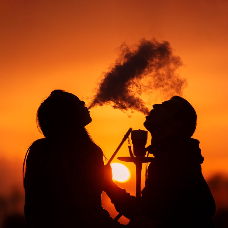 Silhouette Of People Smoking During Sunset