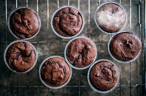 Free Top view of freshly baked brown chocolate muffins placed on metal tray in baking cups Stock Photo