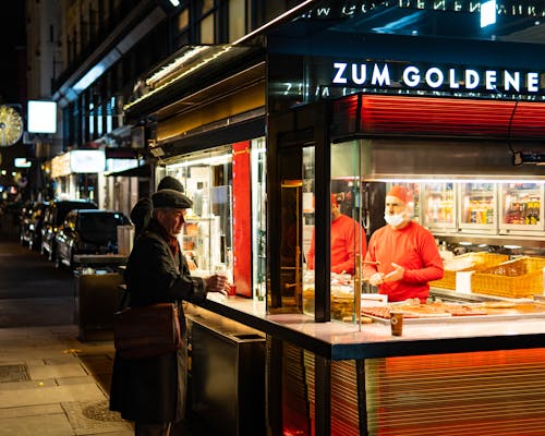 Man Buying Food on a Stall