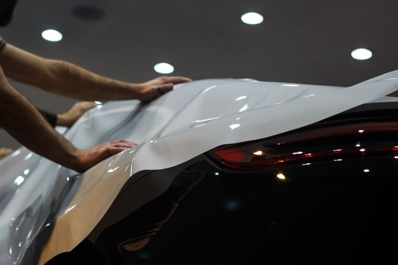 Commercial vehicle vinyl wrap and fleet graphics installation in professional workshop
