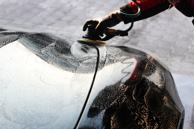 Person Waxing A Car