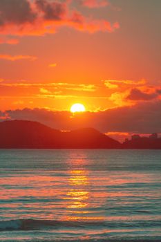 Stunning sunset over the ocean with vivid colors, perfect for travel or nature themes.