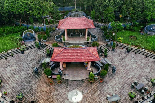 Free From above of Chinese pagoda with red roofs placed in green park with stylish landscape design in daylight Stock Photo