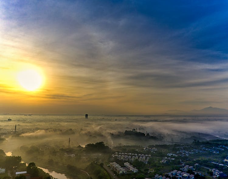 Picturesque Sunrise Over City In Fog