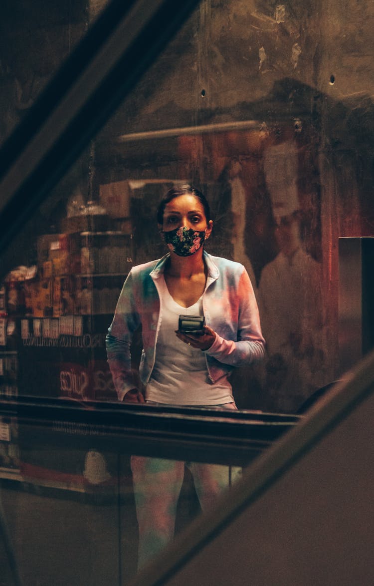 Woman Standing In Dark Room In Mask With Terminal