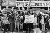 Protest in Buenos Aires with crowd holding banners and signs for social change.
