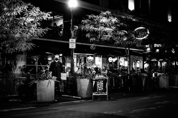 Young Man In Medical Mask Near Restaurant