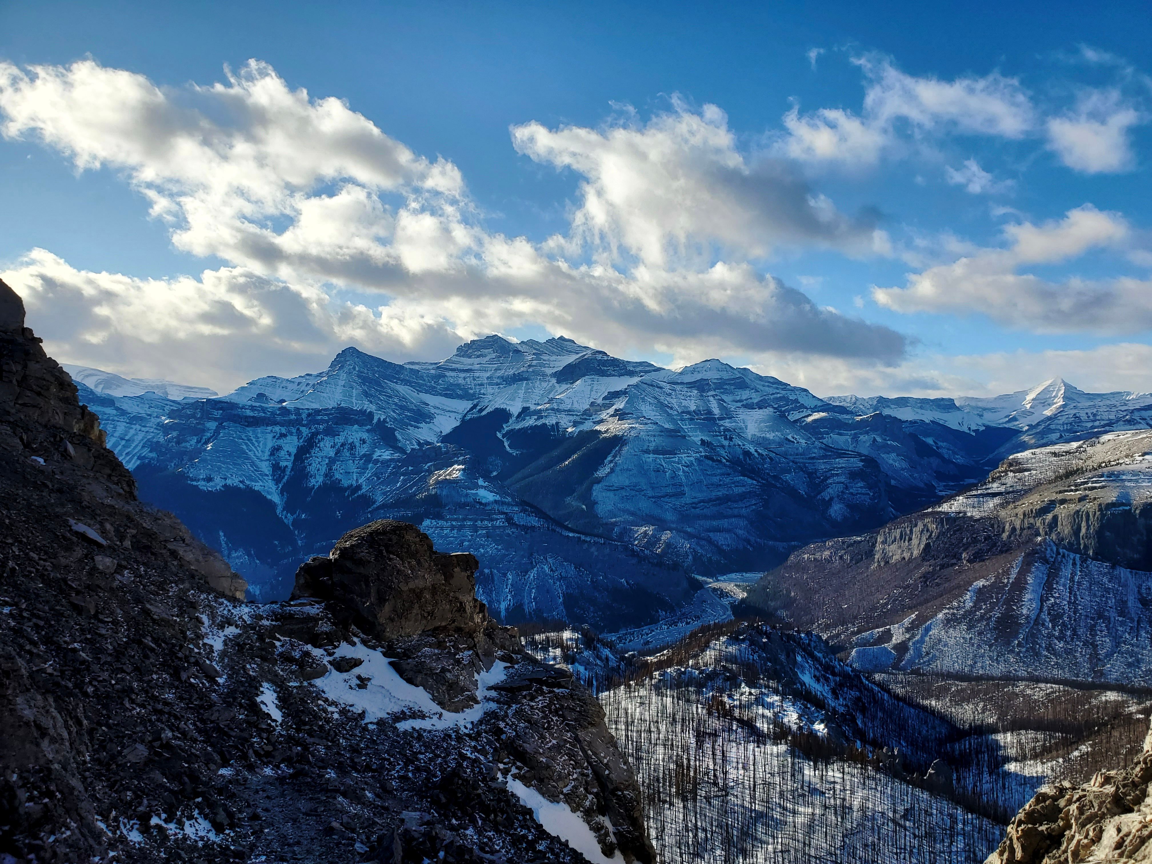 Snow Covered Mountains Under Cloudy Sky · Free Stock Photo
