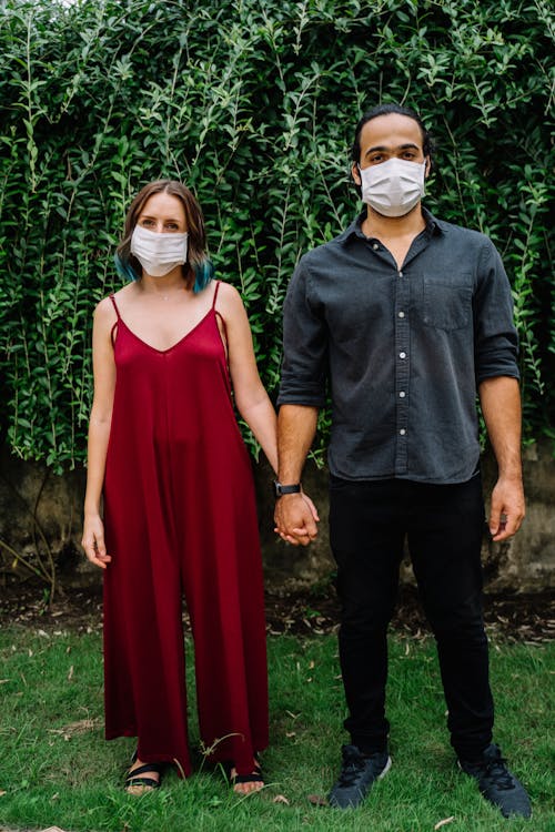 Free Couple Wearing Face Masks Holding Hands Stock Photo