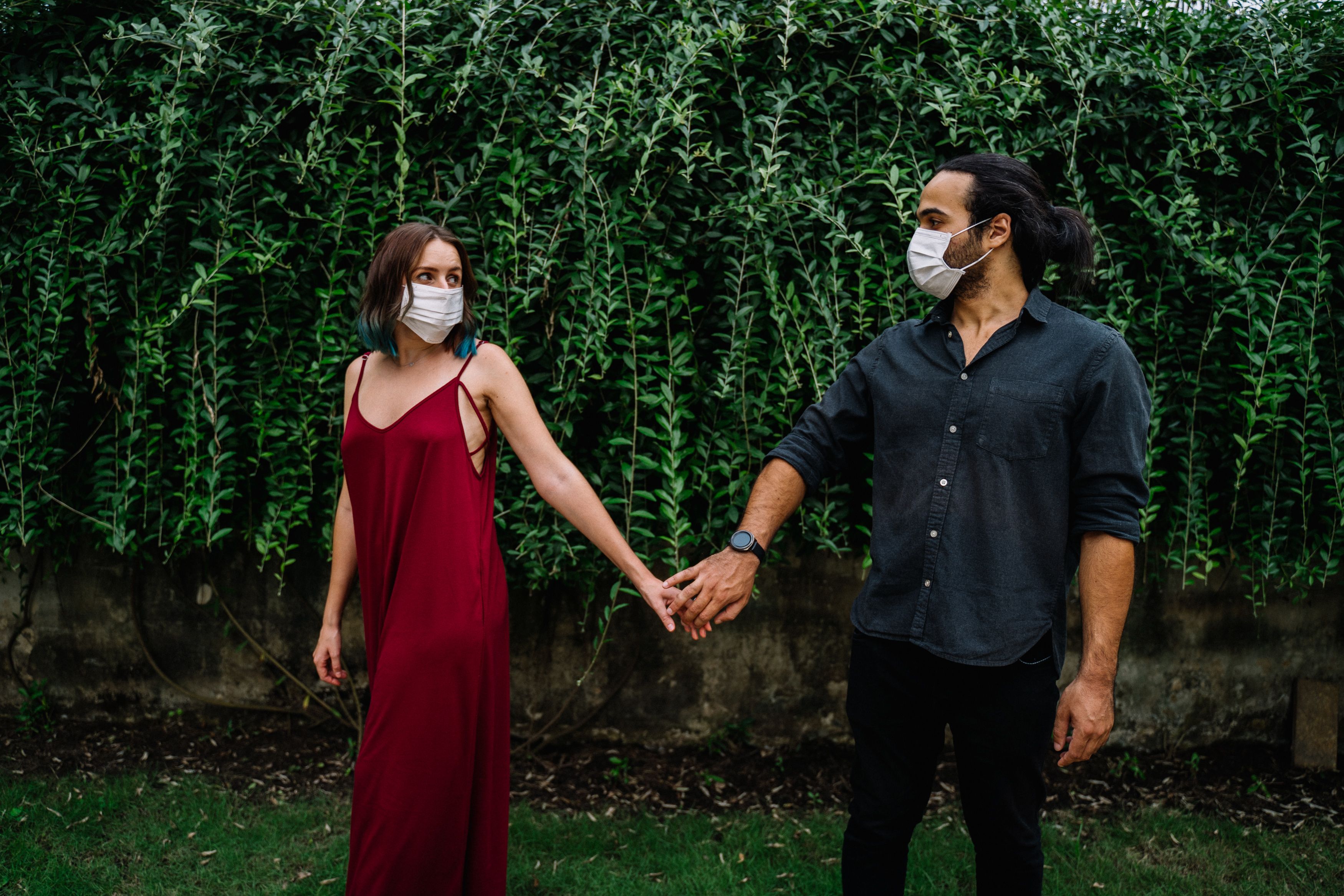 Woman in Red Dress Holding the Hand of a Man · Free Stock Photo