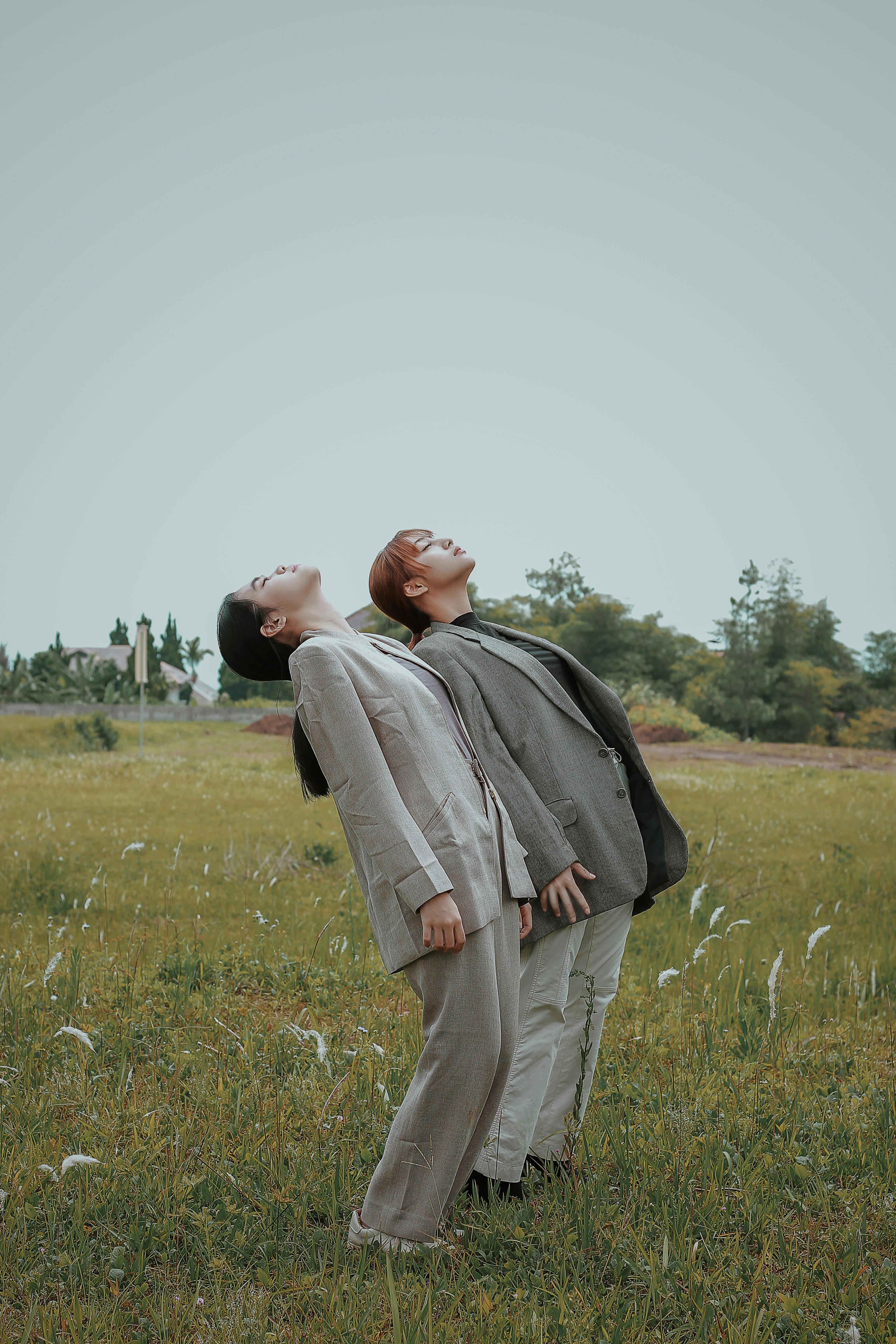 young ethnic women standing in field in daytime