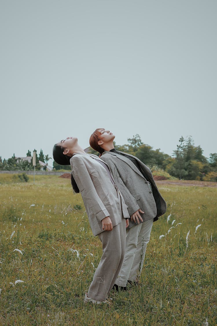 Young Ethnic Women Standing In Field In Daytime