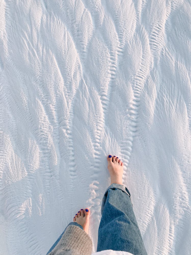 Woman Walking Barefoot On Snow