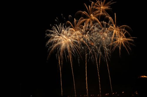Free Golden fireworks illuminating the Montreal night sky, creating a spectacular and vibrant celebration moment. Stock Photo