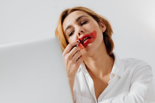 Woman Overdrawing Lips with Red Lipstick
