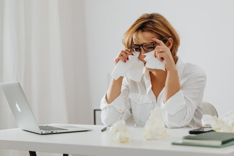 A Sad Woman Wiping Her Tears With Tissue