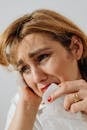 Close-Up Shot of a Sad Woman Holding a Tissue