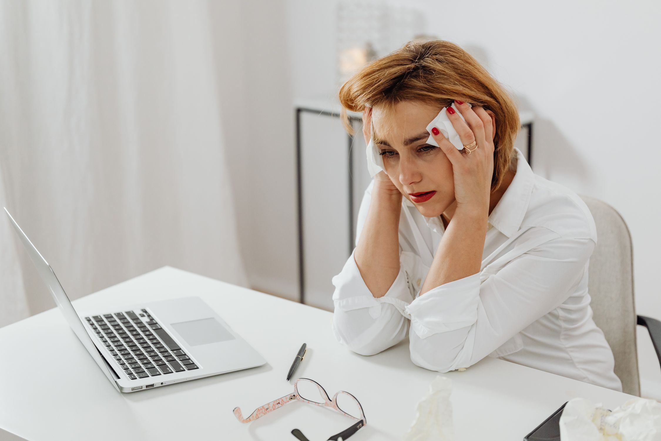 Woman Sitting at a Table Crying · Free Stock Photo