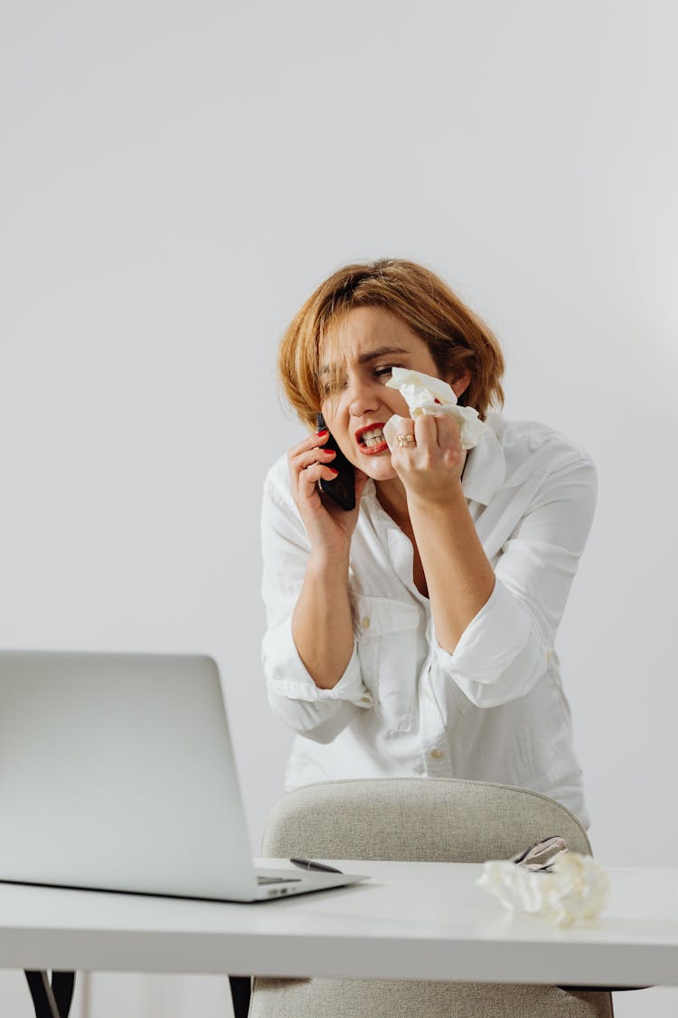 Angry Woman In White Long Sleeves Talking On The Phone