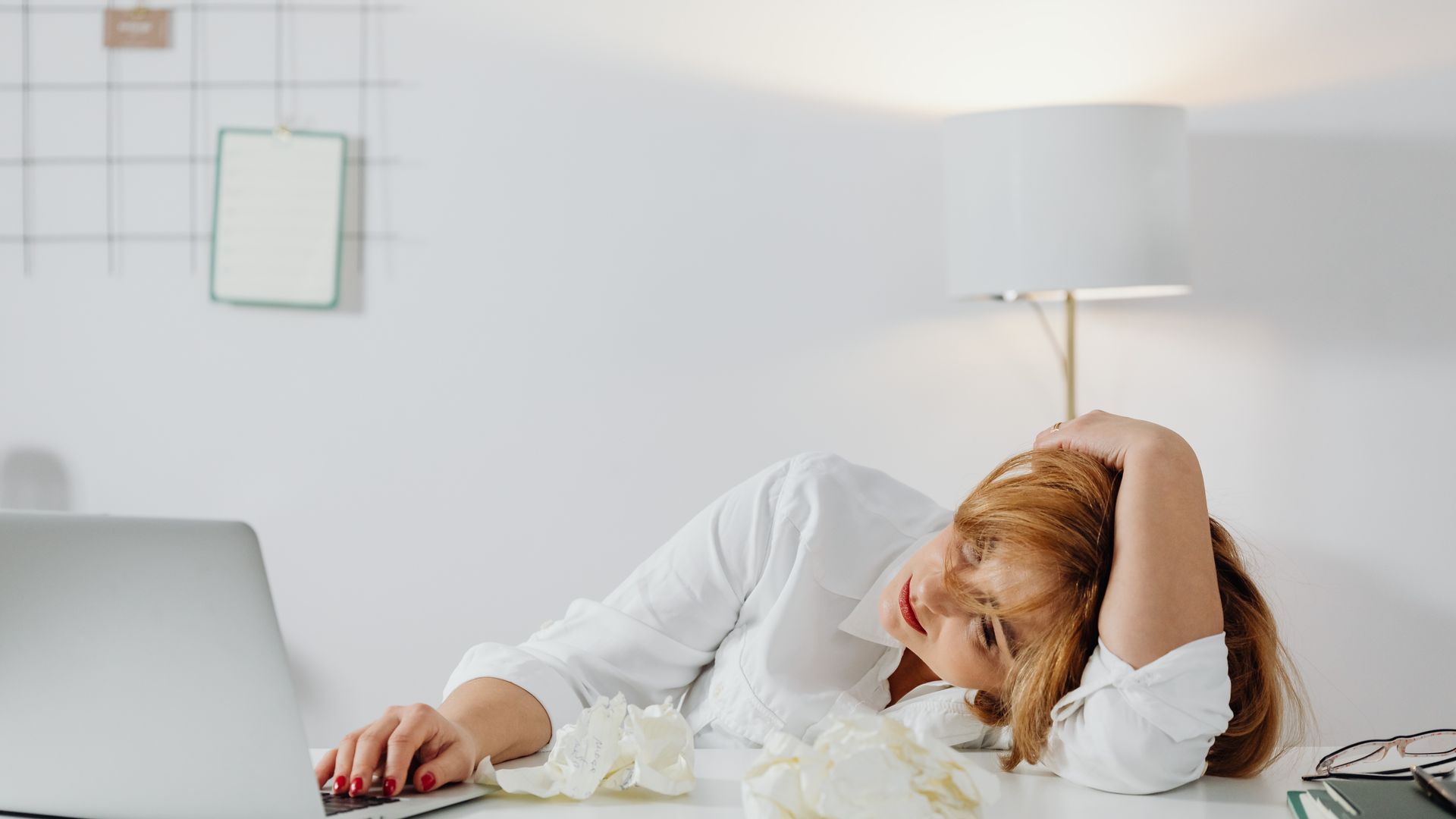 Modafinil for Adrenal Fatigue: Unlocking Energy and Focus Tired woman resting head on desk with laptop, showing workplace exhaustion — modafinil for adrenal fatigue