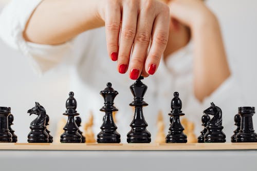 A Person Holding a Chess Piece 