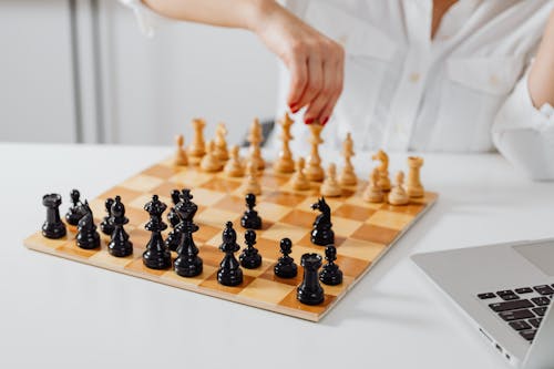 Close-Up Shot of a Person Playing Chess