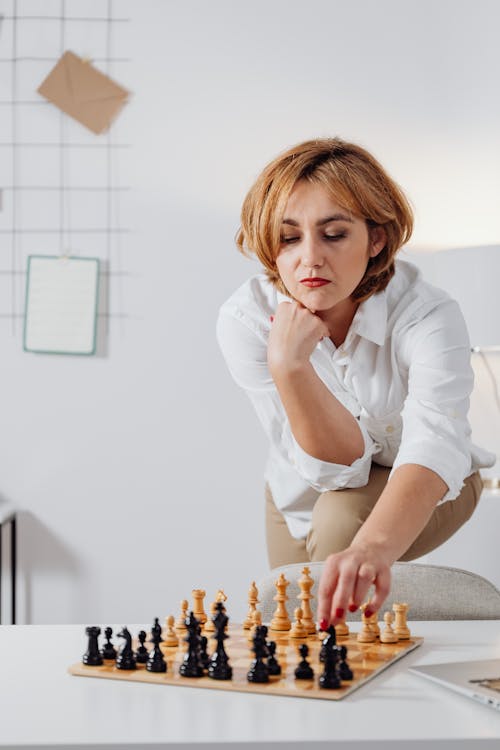 Free A Woman Playing Chess Stock Photo