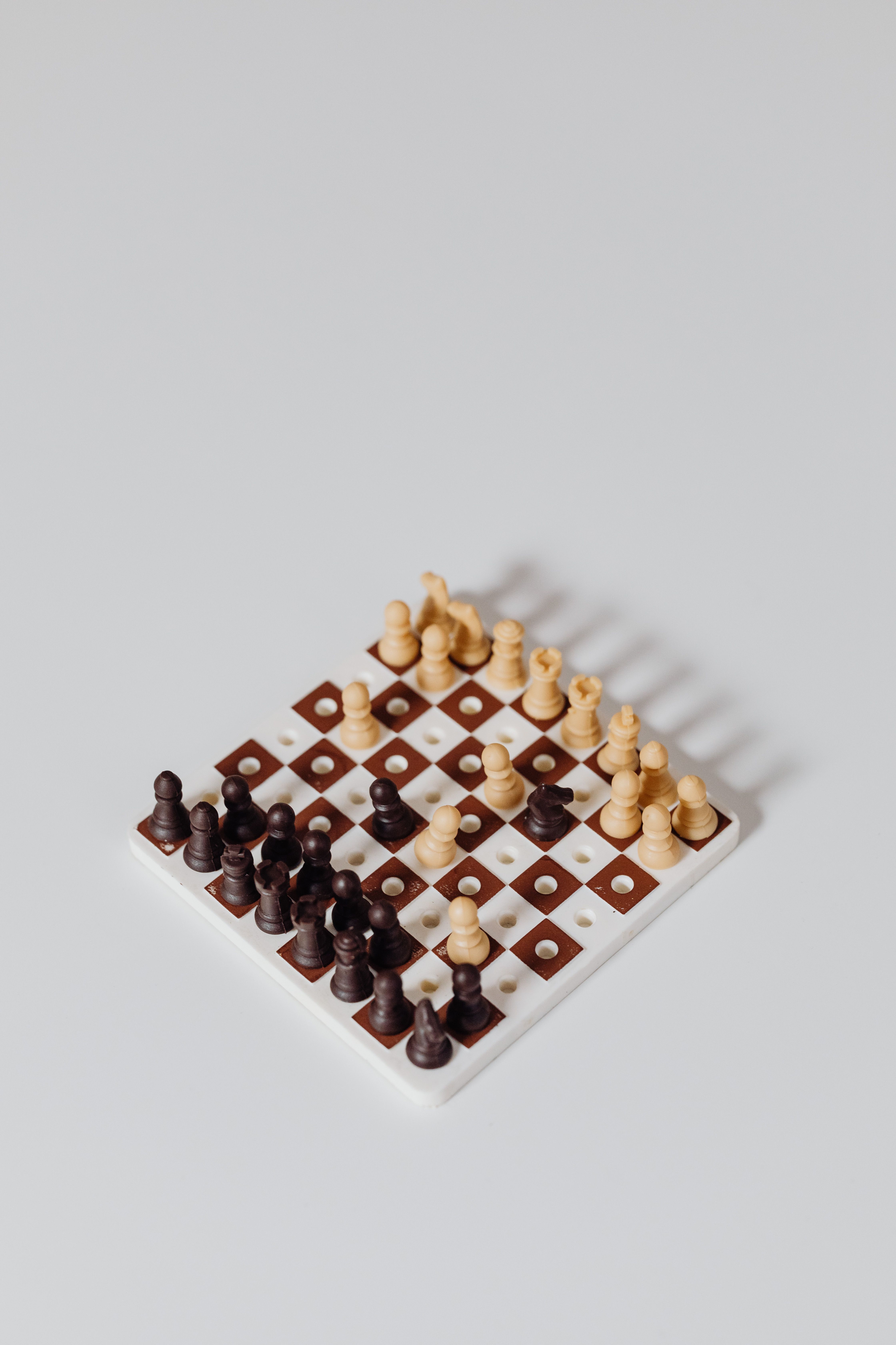 Miniature Chess Toy on White Surface · Free Stock Photo