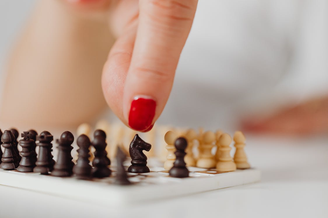 Close-Up Shot of a Person Playing Chess