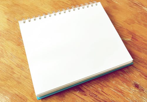 White Notepad on Brown Surface