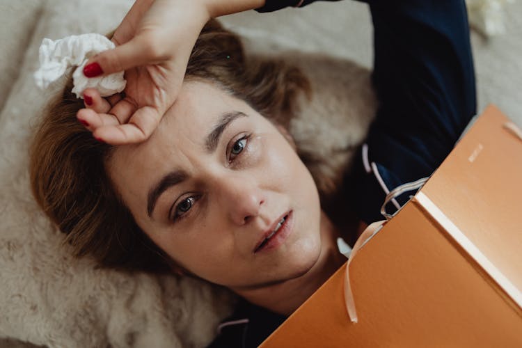 Woman Lying With Tears Falling From Her Eyes