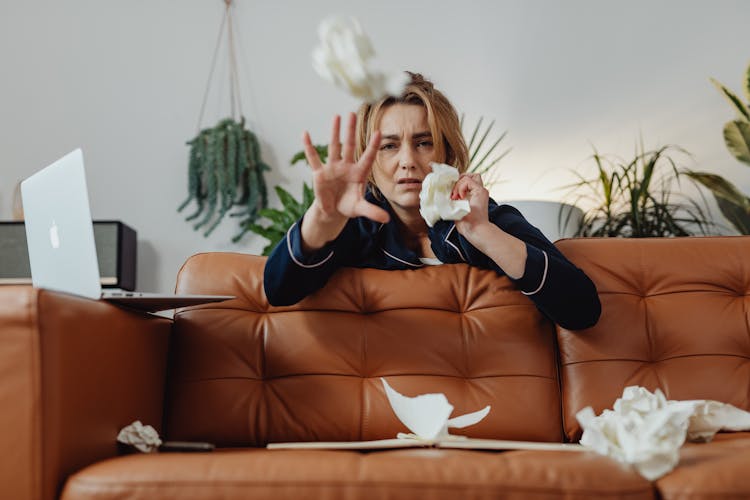 Woman Throwing Crumpled Papers