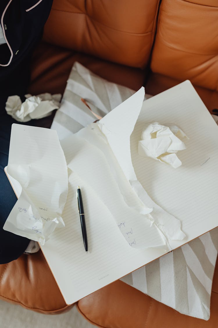 Crumpled Papers And Notebook With Torn Pages