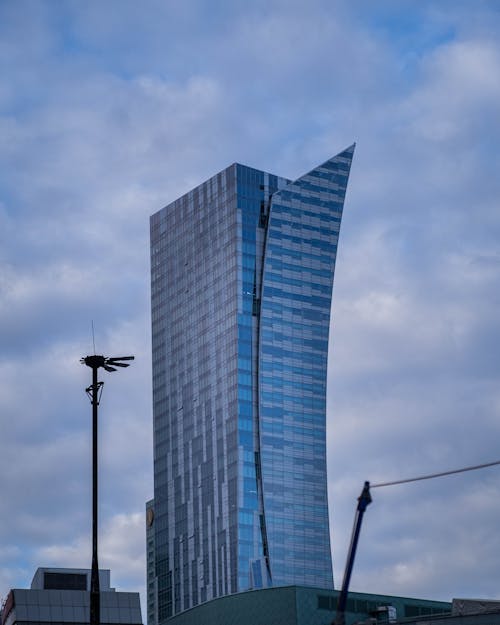 High Rise Building with Glass Panel Windows Under Blue Sky
