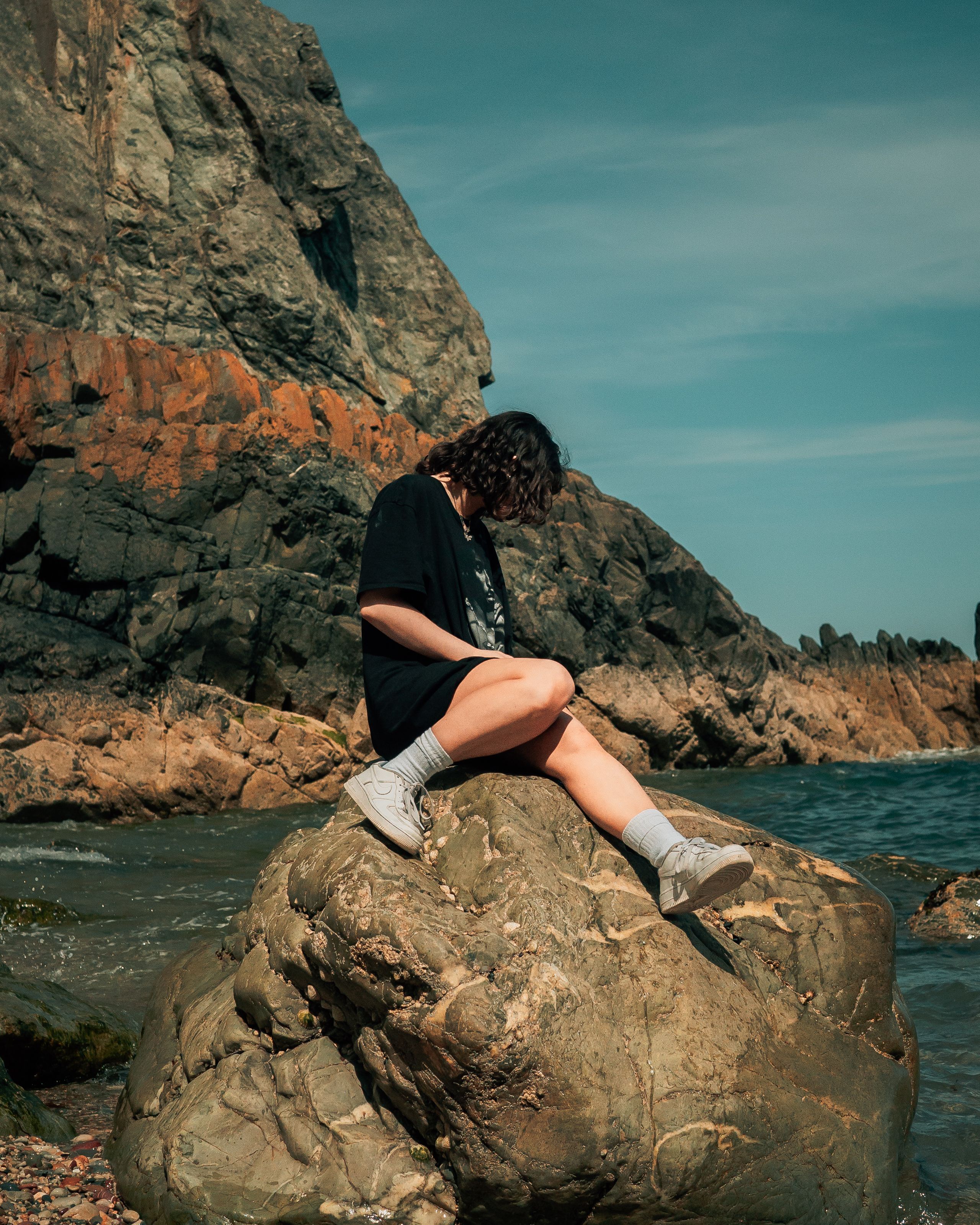 Woman in Black Dress Sitting on a Big Rock · Free Stock Photo