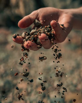 Dramatic capture of stones falling from a hand, outdoors in Dublin.